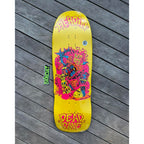Plastic shrink-wrapped Heroin skateboard deck bright yellow with neon pink, red and blue train lines. 'DEAD DAVE' written in neon pink on it and HEROIN branding.