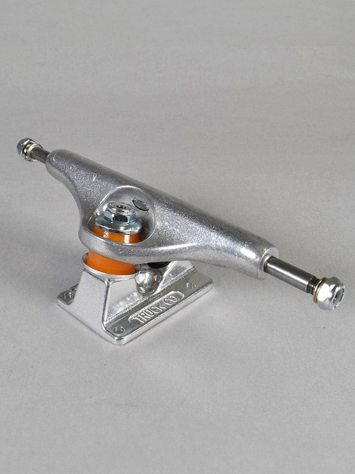 A single skateboard truck with a silver chrome metal body, featuring an orange accent ring and a silver mounting base, photographed on a neutral gray background.