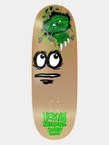 A skateboard deck shown from the underside, featuring a tan background with a cartoon face made from a green alligator head and black eyes and mouth. The text 'HEROIN SKATEBOARD COMPANY CHAMPY' is printed in bright green at the bottom.