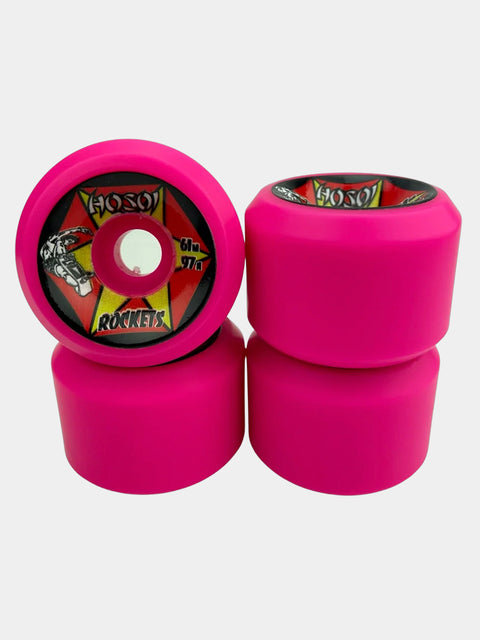 Four bright pink skateboard wheels, with two stacked vertically on the right and one lying flat on the left showing the branded inner core.