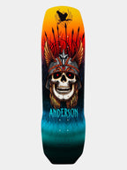 A skateboard deck featuring a highly detailed graphic illustration of a skull wearing a feathered headdress, with a black spider on a pole at the top and the brand name 'ANDERSON' in bright blue text near the bottom.