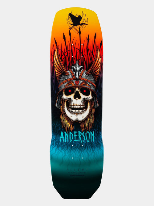 A skateboard deck featuring a highly detailed graphic illustration of a skull wearing a feathered headdress, with a black spider on a pole at the top and the brand name 'ANDERSON' in bright blue text near the bottom.
