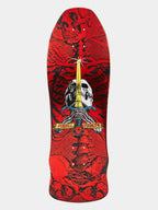 A skateboard deck featuring a graphic design with a red skull and black tribal-style patterns, a white skull at the center, a gold sword, and a banner reading 'Powers & Driven'.