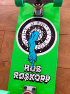 Santa Cruz Rob Roskopp One Old School complete skateboard with a bright green deck, silver trucks, matching green wheels, and a circular black-and-white graphic featuring a blue arm breaking through the centre. 'ROB ROSKOPP' Branding.