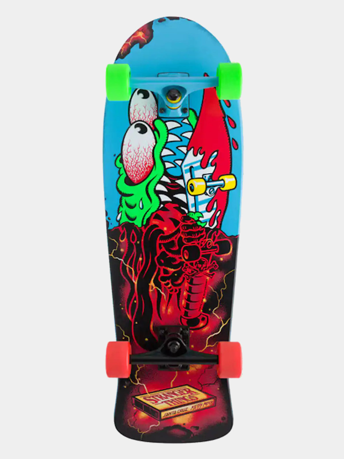 A skateboard deck featuring a vibrant graphic design with a green monster face, red splatters, and a blue background on the upper half, transitioning to a black and red fiery pattern on the lower half. It is shown with bright green wheels and orange trucks against a light gray background.