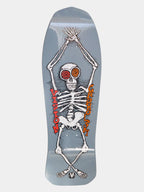 A skateboard deck featuring a large white skeleton graphic stretching vertically, with red spiral eyes and red/orange text reading 'MOTLEY CRASH' on a light gray background.